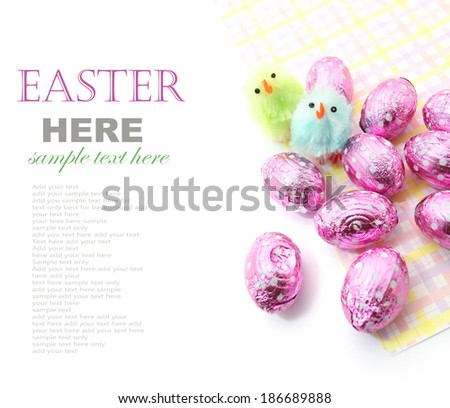Colorful Easter chocolate eggs with little Easter chicken isolated on white