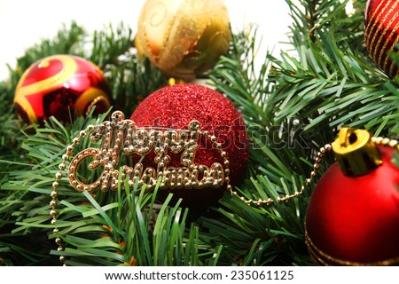 Background with copy space: Christmas decoration (branch of spruce tree, red bubbles and Christmas tag) on the white background