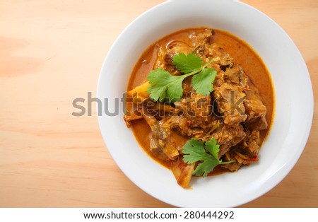 Beef Curry in a bowl on the wooden table with copy space