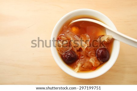 Chinese traditional white fungus or snow fungus soup over wooden table background  with copy space
