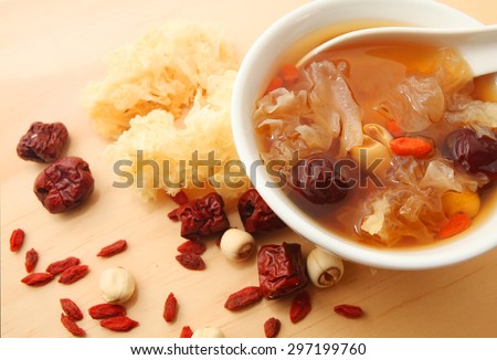 Chinese traditional white fungus or snow fungus soup over wooden table background