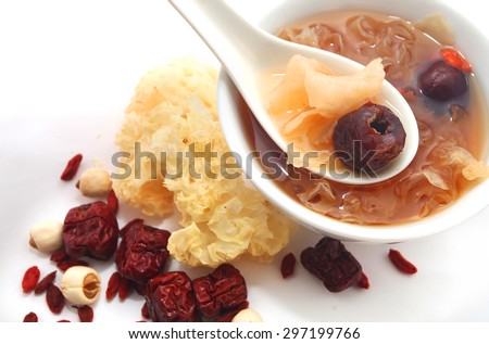 Chinese traditional white fungus or snow fungus soup with the raw ingredients isolated on white