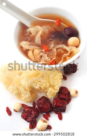 Chinese traditional white fungus or snow fungus soup with the raw ingredients isolated on white