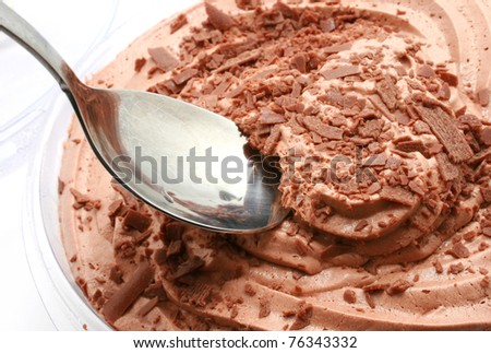 fresh chocolate mousse with spoon isolated on white
