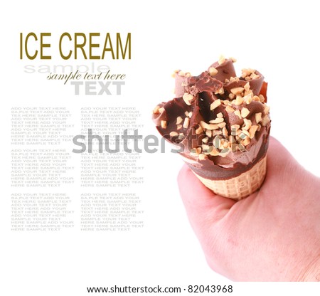 Chocolate ice cream cone with nuts holding by hand isolated on white