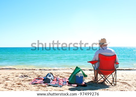 A Man sitting on the chair at the beach