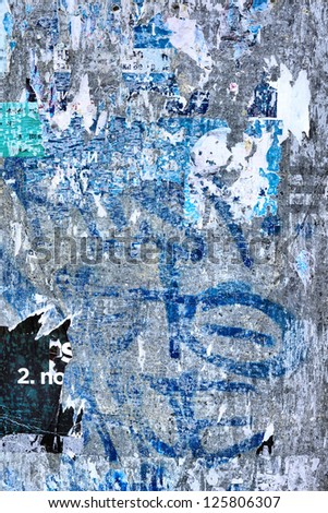 Grunge background on billboard with old torn posters / Torn street poster /