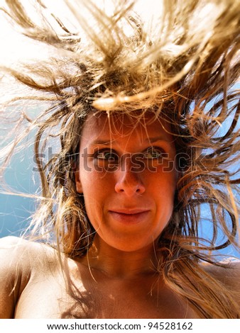 Funny Portrait of Young Woman with Crazy Falling Hair