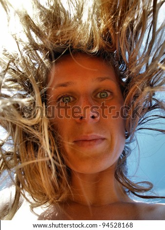 Funny Portrait of Young Woman with Crazy Falling Hair