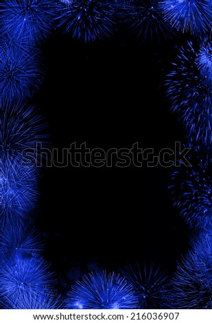 Blue frame or border composed of firework flashes isolated on black background with empty copyspace in the middle to insert some text or images.