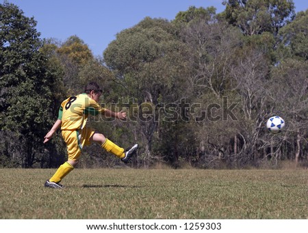 kicking soccer ball. stock photo : Kicking soccerball on field