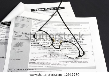 Close up of Real Estate contract with reading glasses