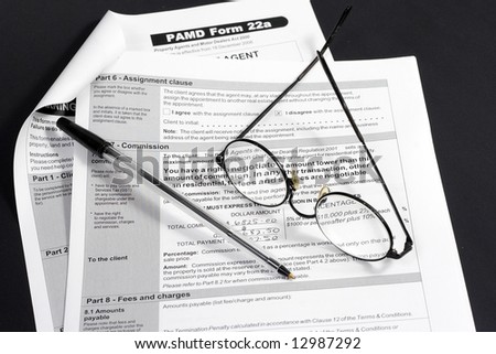 Close up of Real Estate contract with reading glasses and pen