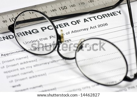 Close up of Power of Attorney contract with reading glasses