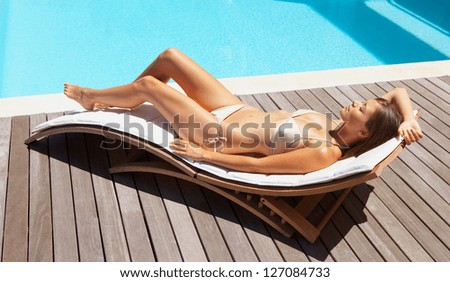 Summer young woman sunbathing in bikini