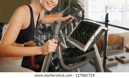 woman at the gym exercising. Run on on a machine