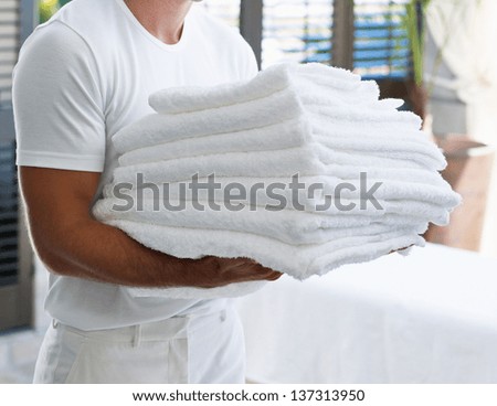 man with a towel on his arm
