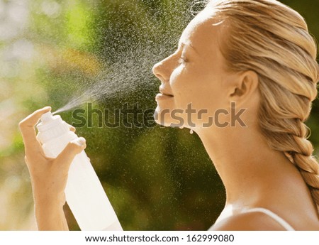Young female washing her face