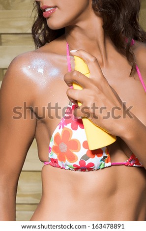 female with sun care lotion