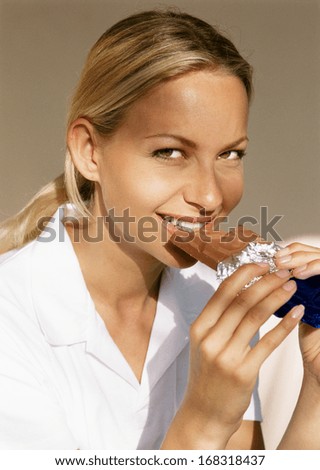 young happy woman eating chocolate