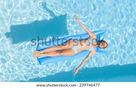 woman on an air mattress in the swimming pool