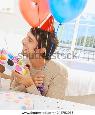 portrait of young man blowing a balloon