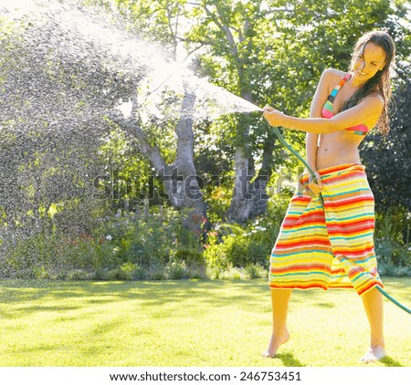 Summer garden grass woman play with water