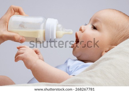 baby infant eating milk from bottle