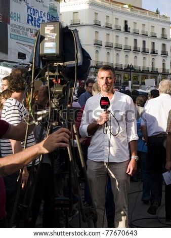 MADRID; SPAIN - MAY 20: Popular demonstration against political class on May 20; 2011 in Madrid; Spain. A journalist of the VRTNieuws Channel reporting the Spanish Revolution.