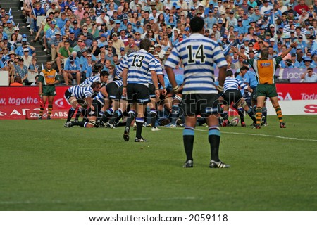 Rugby players in a loose scrum