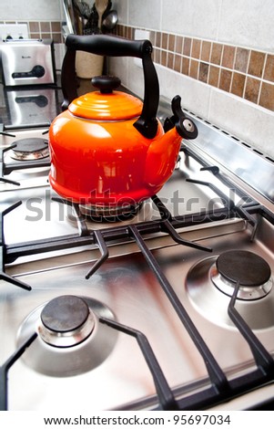 Red kettle on a gas stove