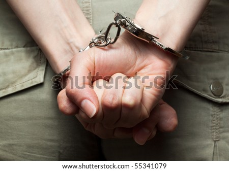 Dramatic photograph of woman´s hands in handcuffs (close-up)