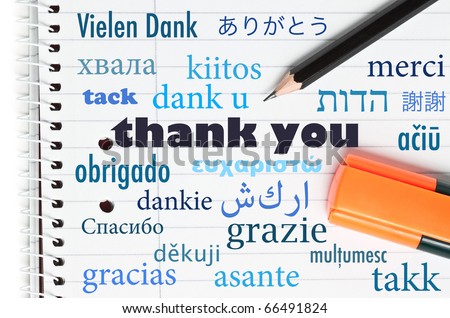 Thank you in many different languages written on an open notebook