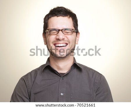 Young caucasian man with glasses laughing