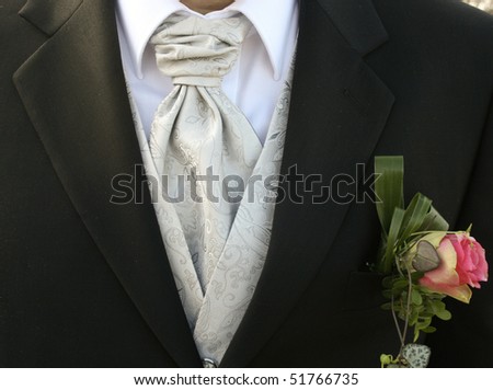 stock photo A bridegroom with a nice grey silk tie and a flower decoration
