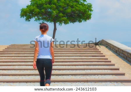 Runner girl - athlete running the stairs in the summer, woman fitness