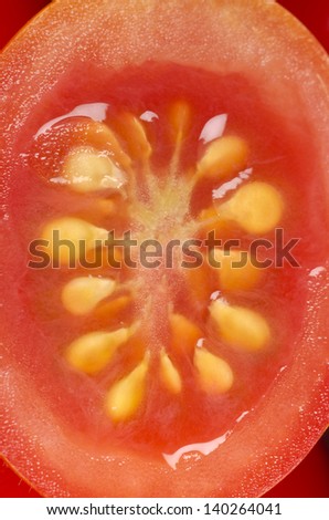 Extreme close-up of sliced cherry tomato Macro view of a small tomato slice