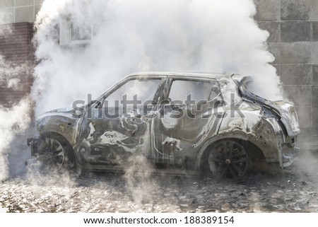 Vapor heat after extinguishing a burning car This car had to be splashed completely with water to extinguish it from having caught fire.