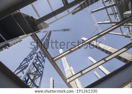 Structural design and jib crane Low-angle shot of a several metal columns and girders of a construction site