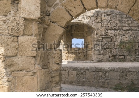 Fortress arches in the crusade city of Rhodes, Greece Looking through ruins of the palace constructed by English Knights in Rhodes, Greece