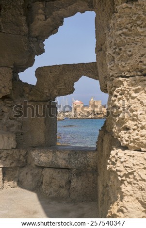 Fortress arches in the crusade city of Rhodes, Greece Looking through ruins of the palace constructed by English Knights in Rhodes, Greece
