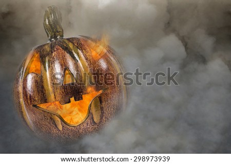 Illuminated Jack Oâ??Lantern clay pumpkin\
Jack o\' lantern aglow within smoke