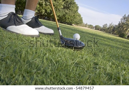 Golfer stepping up to his ball just about to swing