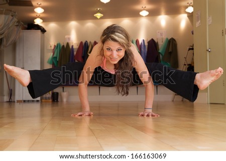young female in yoga studio doing yoga poses