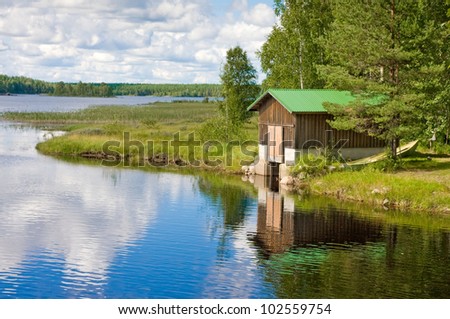 Boat and wooden house on the lake in Finland