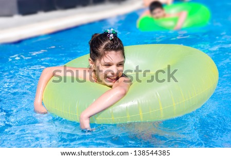 Girl swims in  pool in circle