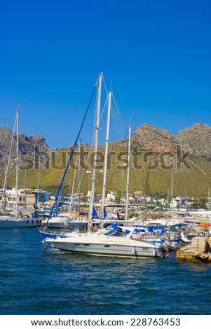 Yacht in harbor and mountains of Port de Pollenca,  northeast coast of spanish island Mallorca in Mediterranean Sea, Europe
