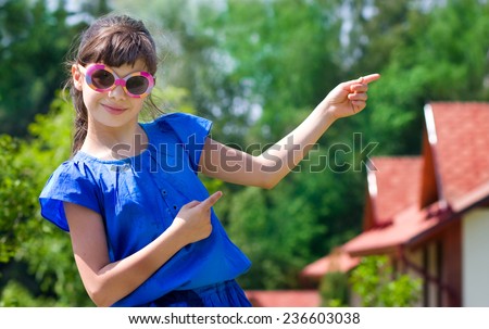 Girl pointing at new cottages