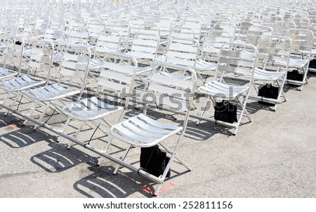 Rows of empty metal chair seats installed for some business event or performance,festival