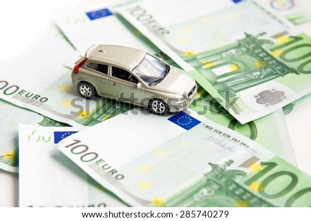 Toy car and euro on white